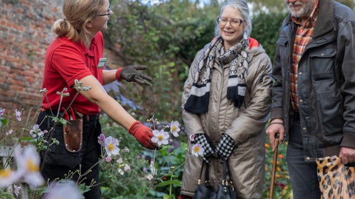 Gardener talking to visitors at the South Border at Beningbrough, North Yorkshire